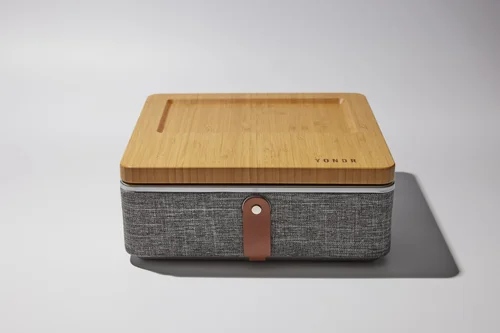 The premium Yondr Home Tray shown in a living room, functioning as a stylish signal-blocking box.