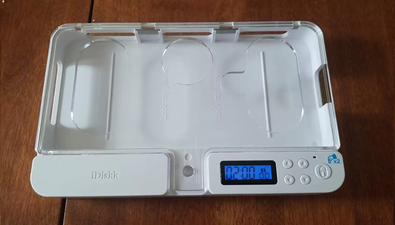 The ySky Phone Lock Box with its timer lit, sitting on a modern wooden desk.