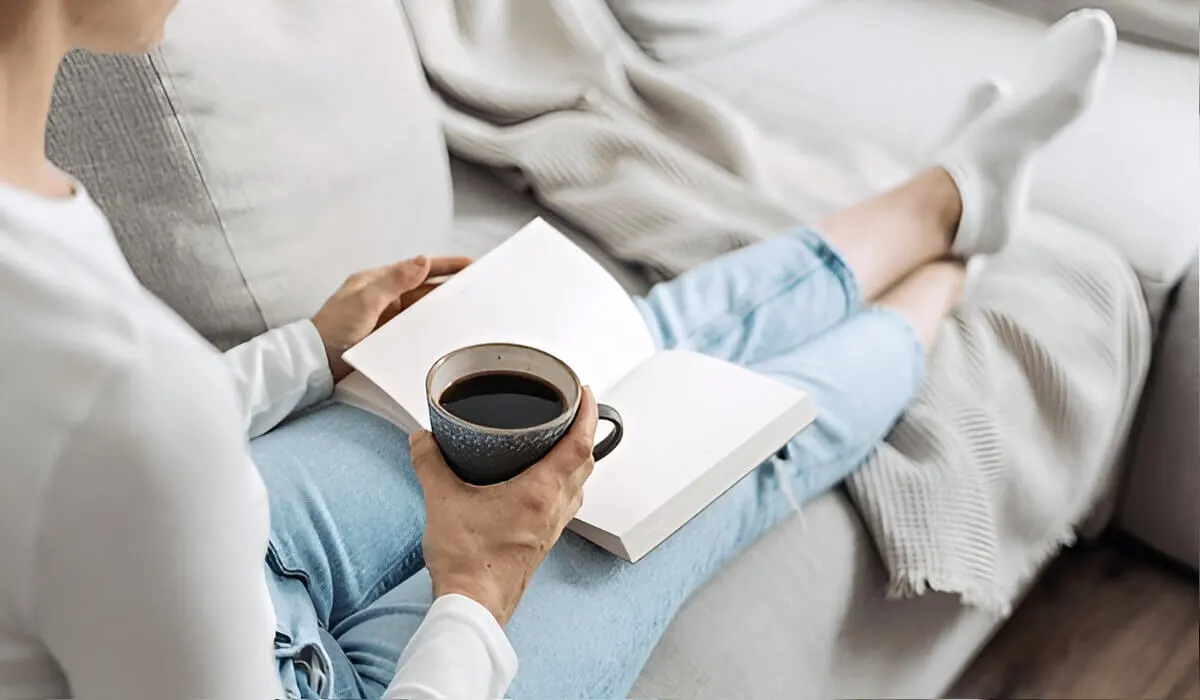 A person looking relaxed and focused while reading, free from their phone's distractions.